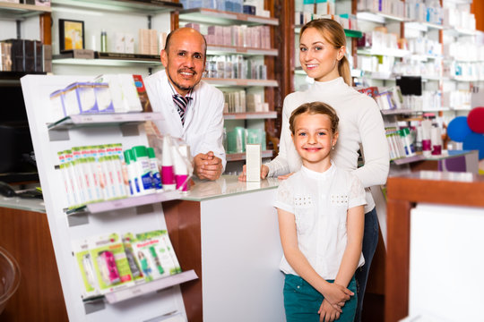 pharmacist standing with a cash desk
