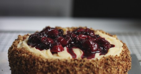 Adding cream and fruit to cake