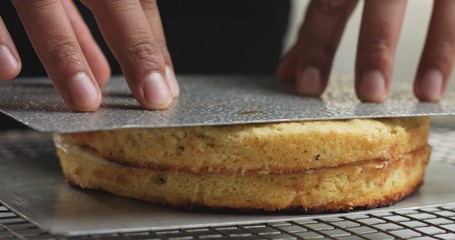 Adding cream and fruit to cake