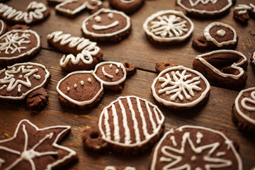 Traditional homemade Christmas ginger and chocolate cookies decorated with white sugar painting