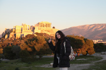 Young girl near fair sunset acropolis.Student in Athens,Greece.