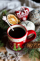 Obraz na płótnie Canvas Christmas black coffee in the red cup with toys