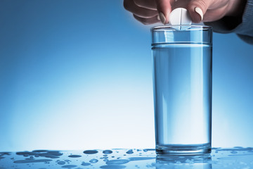 effervescent pill into a glass of water