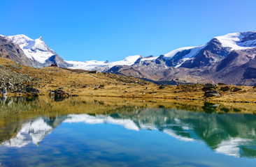 Fototapeta na wymiar Snowy mountains reflected in Stellisee Lake in Zermatt, Switzerland.