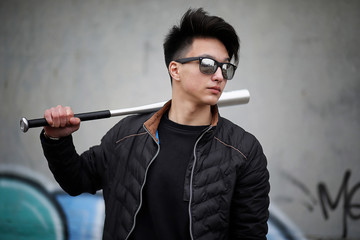 Asian young man on the street posing at the camera