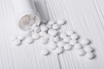 Fototapeta na wymiar Medicine pills on white table