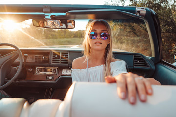 Girl posing in a convertible