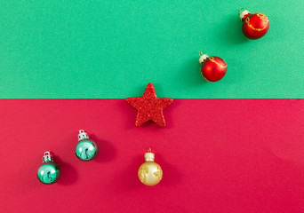 Christmas star and balls arranged diagonally on green and red