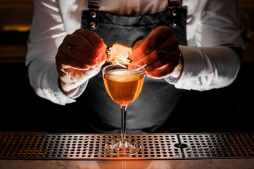 Bartender making the fresh alcoholic drink with a smoky note