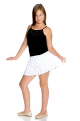 A teenage girl in a short white skirt and a black T-shirt.