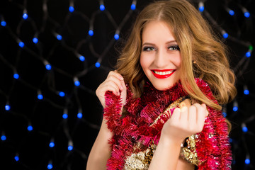 Beautiful woman with new year decoration on black background