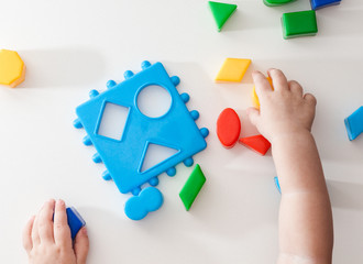 Children playing with montessori toys, educational toys, arranging and sorting colors and sizes.