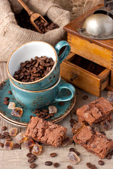 Chocolate cookies and cup of aromatic coffee on wooden table