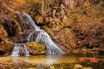 Fototapeta na wymiar Beautiful waterfall in forest, autumn scene.