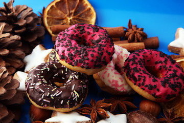 assorted donuts with chocolate frosted, pink glazed and sprinkles donuts..