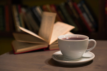 A cup of tea and an open book, a soft focus