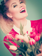 Fototapeta premium Woman holding bouquet of tulips flowers