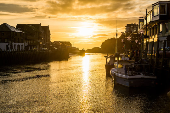 Sunrise at the mouth of Looe harbour with beautiful sky, Cornwall, UK