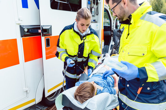 Sanit&auml;ter messen Blutdruck von verletztem Jungen 