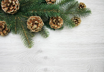 Obraz na płótnie Canvas Christmas and New Year's composition. The pine cones, spruce branches on a wooden white background