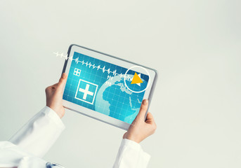 Close of female doctor hands working with tablet pc computer