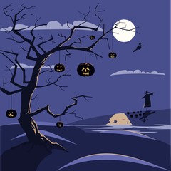 Dry tree with Halloween pumpkins in the moonlight