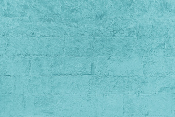 Plastered brick wall, large bricks, color toning, surface