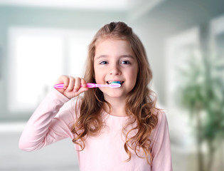 Child girl cleaning teeth in bathroom.Dental health.