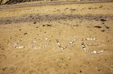 love on the golden sand of myrtos beach on the island of kefalonia greece