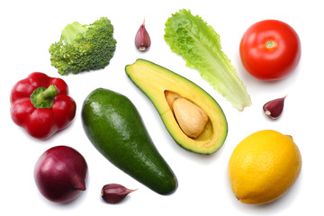 healthy food. mix of avocado, lemon, tomato, red onion, garlic, sweet bell pepper and rucola leaves isolated on white background top view