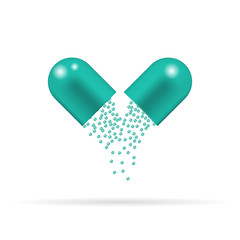 Capsule pill with green granules which are sprinkling and falling down. Tablet isolated on the white background.