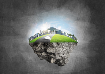 Modern cityscape with towers and skyscrapers on green part of land