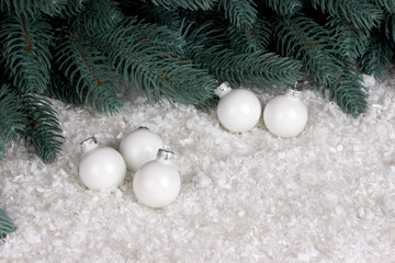 Fototapeta na wymiar Christmas decoration with white chrismas ball snow and fir branches.