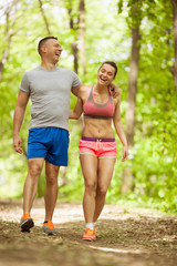 Fototapeta premium young happy fitness couple in forest