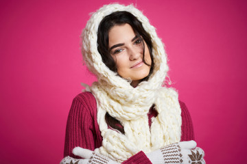 woman in white scarf on head, pink background, new year