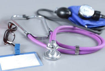 stethoscope, Red heart, glasses and blood pressure meter on white background. Selective focus.