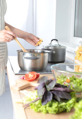 Fresh vegetables on the cutting board, salad in a glass dish. Concept of cooking
