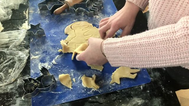 children's hands making unicorn christmas cookies