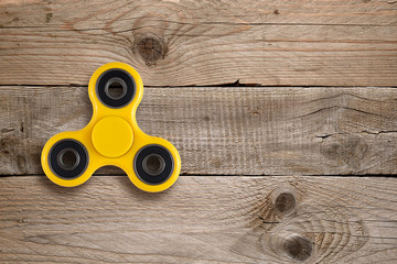 Fidget spinner toy on wooden table