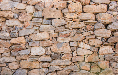 Background of stone wall texture photo. Greek ancient wall texture. Pattern of stone wall decorative surfaces.