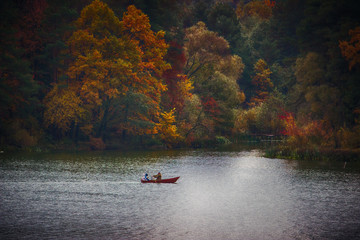 silhouette of a people on a boat in the autumn at sunset