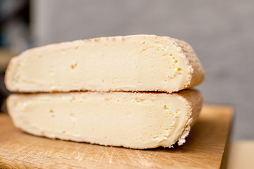 Close-up view on the slice of young soft cheese