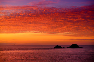 Obraz na płótnie Canvas Sunset over Porth Nanven in the Cot Valley of Cornwall, England
