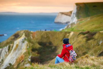 Tourist enjoying view of Man O'War Cove on the Dorset coast in southern England, between the...