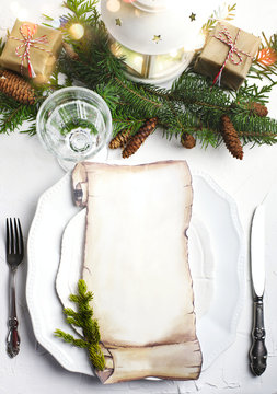 Christmas place setting with blank paper for writing the Christmas menu.