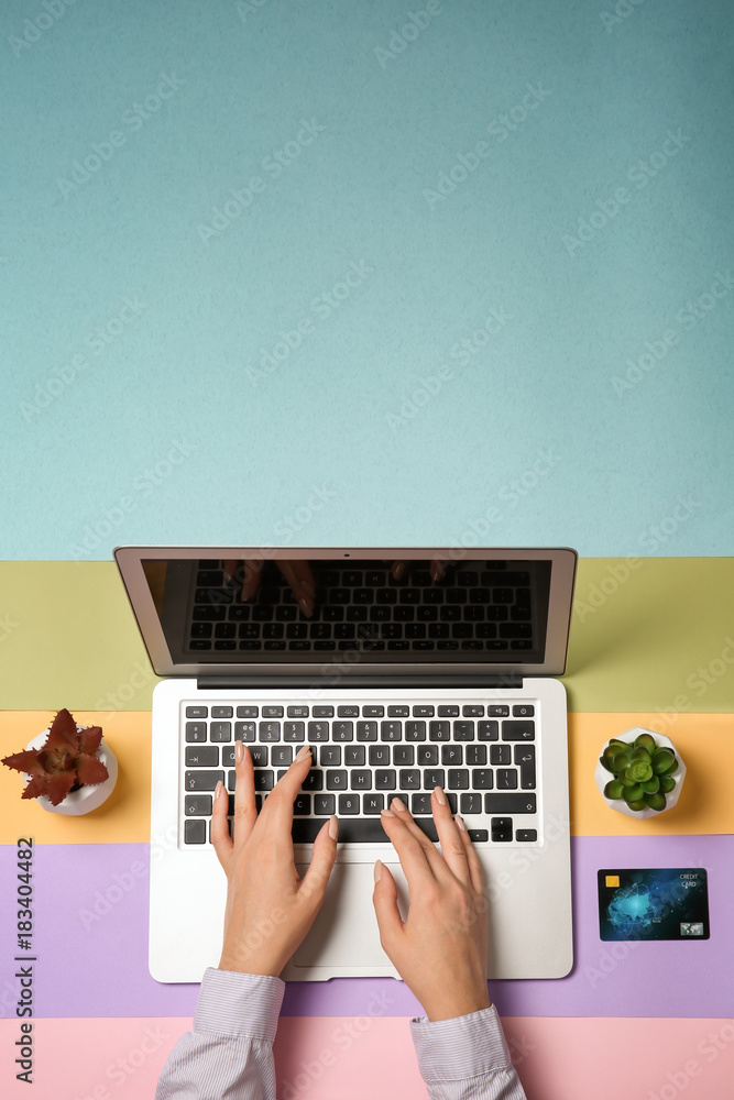 Sticker young woman using laptop for online shopping on color background