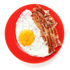 Plate with fried egg and bacon on white background