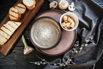 Mushroom cream soup with champignons served with croutons
