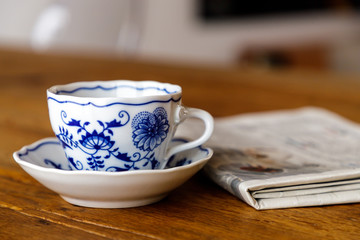 Decoration coffee cup in wood table with Newspaper