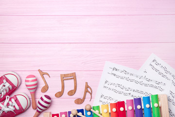 Beautiful composition with music sheets on wooden background. Baby songs concept